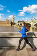 London running woman training for marathon. Sport girl jogging in city near Big Ben and Westminster bridge, exercising on the way to work. Morning workout to the office.