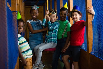 Portrait of smiling children in jungle gym