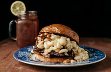 Chopped Brisket Mac And Cheese Sandwich With Bbq Sauce On Rustic Background