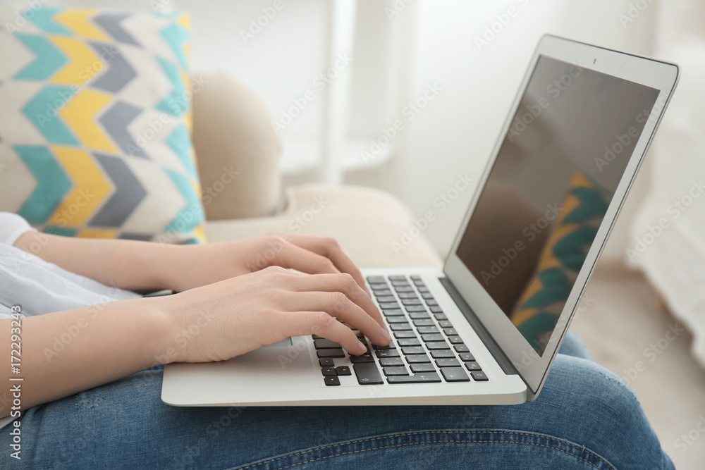 Young woman working with laptop at home