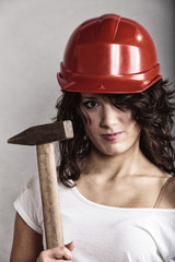 Wall Mural - Sexy girl in safety helmet holding hammer tool