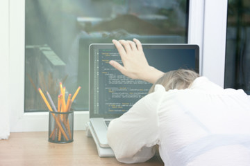 Wall Mural - woman freelance programmer working from home. website code on screen.