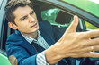 © Artem - Upset driver man in the car. Quarrels and discontent in the road