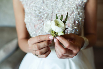 Wall Mural - Bride holds little white boutonniere in her arms