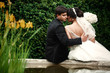 © IVASHstudio - Lovely bride and groom sit on a fountain in the garden
