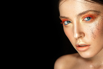 Beautiful woman portrait with colorful make up in bronze colors and splashes on face.