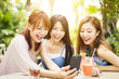 © Tom Wang - Group of friends having fun and looking at smart phone