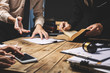 © makibestphoto - Teamwork of business lawyer meeting working hard about legal regislation in courtroom to help their customer.