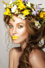 Beautiful woman portrait with flowers on head and yellow lips.