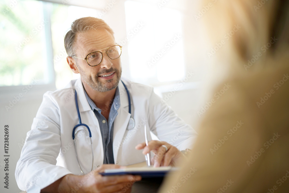 Doctor with patient in medical office