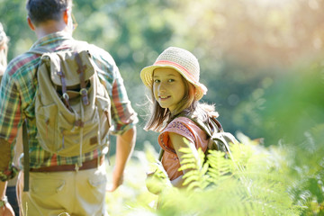 Wall Mural - Portrait of young girl on a rambling day with parents