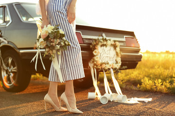 Wall Mural - Beautiful young bride near decorated car outdoors