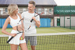 © Africa Studio - Two happy tennis players on court