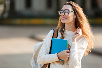 Poster - Image of pleased brunette woman in eyeglasses and autumn clothes