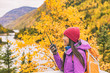 © Maridav - Woman talking on ham radio portable transceiver. Autumn hiker camping. Amateur radio operator woman speaking on handheld walkie-talking in mountains nature.