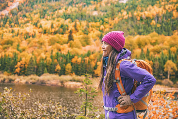 Wall Mural - Hike woman with backpack walking in forest nature outdoors bridge. Canada travel hiking tourism at Hautes-Gorges-de-la-Riviere-Malbaie National Park. Active tourist lifestyle.