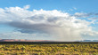Storm Monument Valley. Isolated rainstorm at the Monument Valley with sunshining surround it and sunny mountains on the background. View from US Hwy 163, Oljato Monument Valley, Arizona, AZ 84536, USA