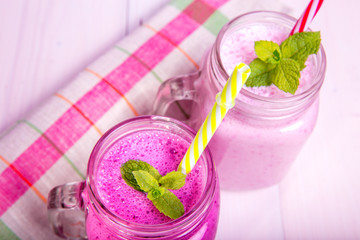 Poster - Berry milkshake or smoothie with ingredients and mint. Healthy drink in mason jar.