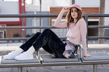 Street Style Fashion. Pink Sheer Long Sleeve Blouse, Black Crushed Velvet Pants, Coordinating With A Pink Hat. 