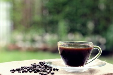 Morning coffee closeup outdoor garden blur background