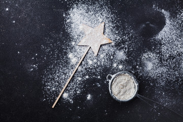 Wall Mural - Black table with flour for christmas baking. Top view.