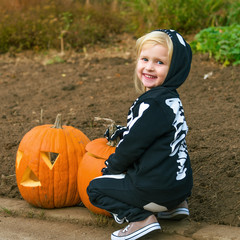 Wall Mural - smiling child with Halloween pumpkin Jack O’Lantern