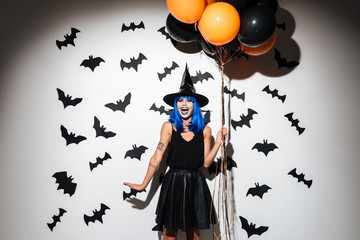 Emotional young woman in witch halloween costume