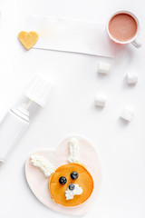 concept kid breakfast with pancake top view on white background