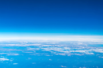 Wall Mural - blue sky and cloud top view from airplane window,nature background
