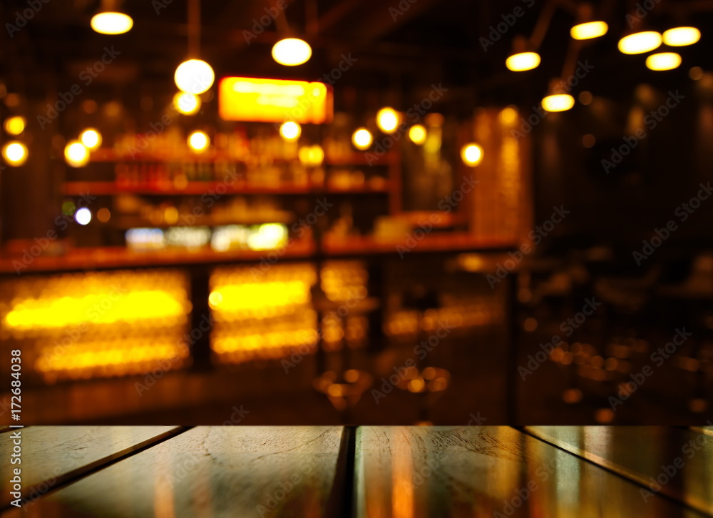 top of wood table with light reflection with abstract blur bar or club in the dark night background - obrazy, fototapety, plakaty 