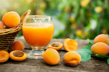 Wall Mural - Juice and fresh apricots on the table