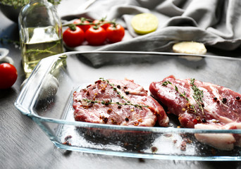 Wall Mural - Baking dish with fresh raw steaks on table