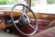 Steering Wheel And Wood And Leather Interior Of A Vintage Car