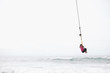 © Rob and Julia Campbell/Stocksy - Young girl flying over ocean water on rope swing