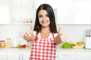 Beautiful young woman in the kitchen