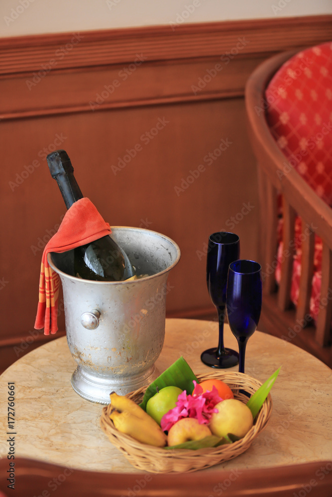 Fruits and champagne prepared for romantic date in hotel room
