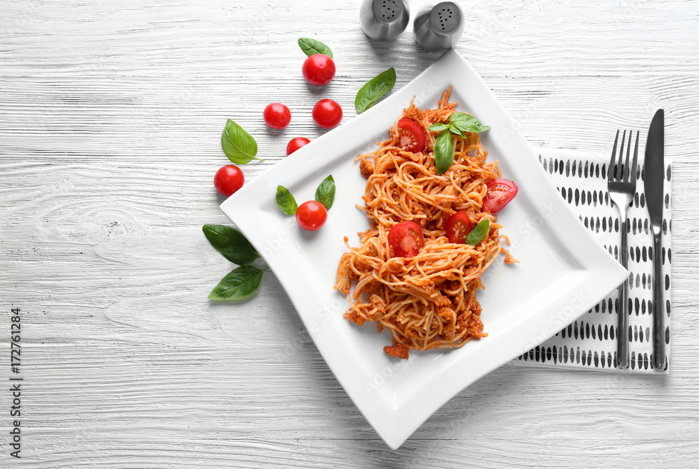Plate of delicious pasta with bolognese sauce on table