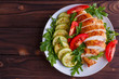 Healthy food, diet concept. Baked chicken breasts with zucchini and salad, copy space, flat lay