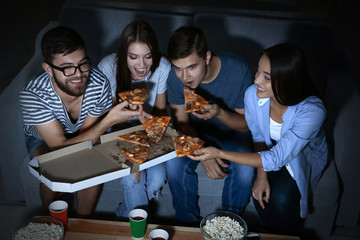 Wall Mural - Friends watching TV in evening at home