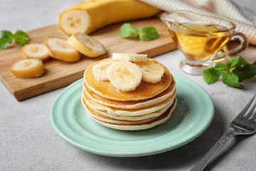 Sticker - Plate with yummy banana pancakes on kitchen table