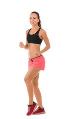 Wall Mural - Beautiful young woman in sportswear running on white background