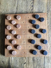 Old Checkers Board On A Wooden Table Ready For Play,