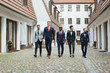 © Julien L. Balmer/Stocksy - Group of Four Stylish Young Men in Suits Walking Down in Courtyard