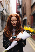 Young Woman Texting A Message On The Mobile Phone