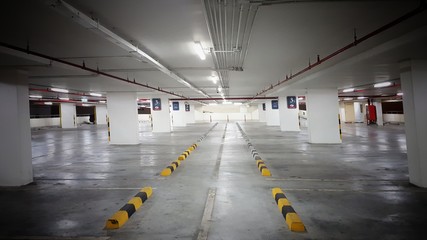 Indoor parking  in shopping center with copy space. The parking lot has enough light so it is safe.car park.