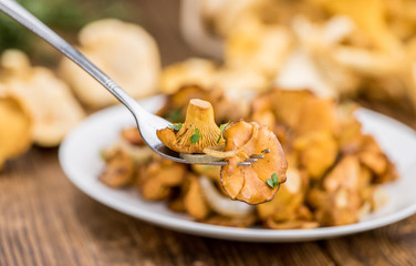 Wall Mural - Fresh made Fried Chanterelles on a rustic background