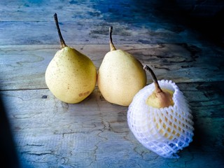 fresh pears on a rustic background.