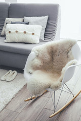 Poster - Rocket chair with sheep skin rug in scandinavian living room