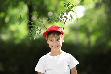 Wall Mural - Boy with horns made of tree branches outdoors