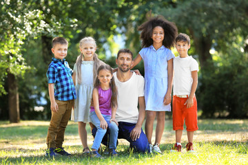 Wall Mural - Group of children with teacher in park